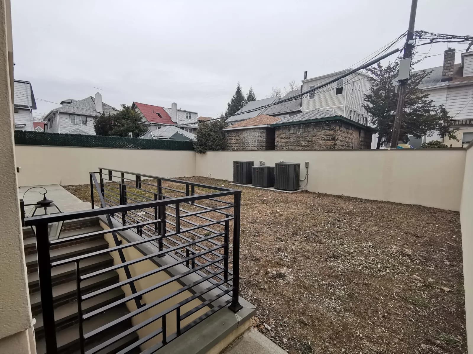 Same backyard, from the rear landing — 917 E 27th St, Brooklyn — before