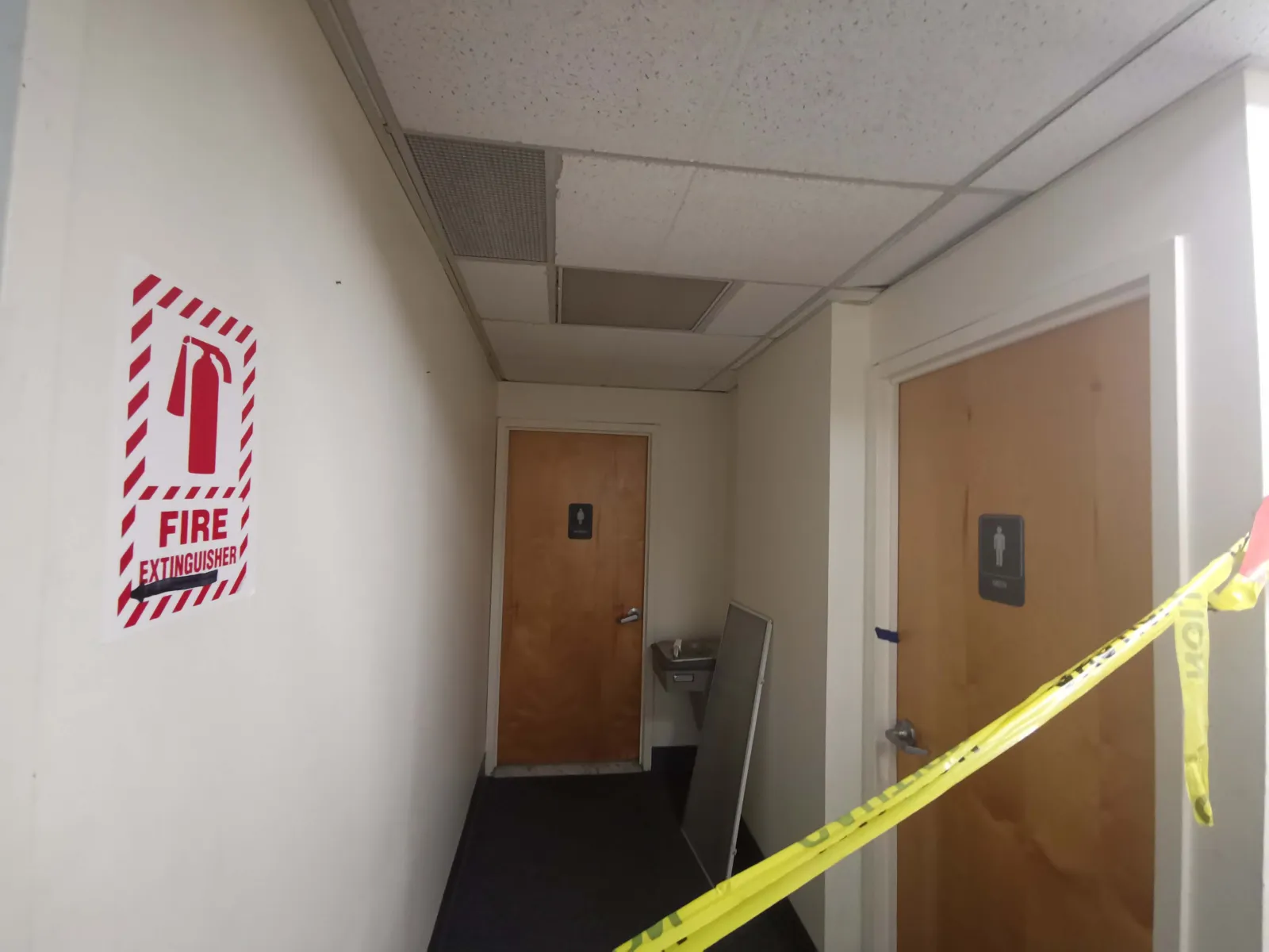 4105 Avenue V Office — Restroom corridor & water fountain — before