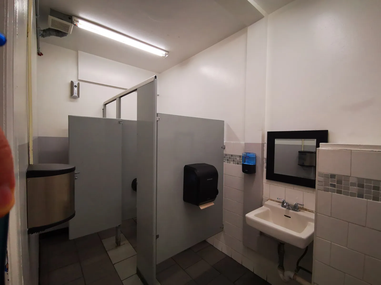 475 East 57th Street — Old sink wall replaced with a sleek vanity and bold accent-tile design — before