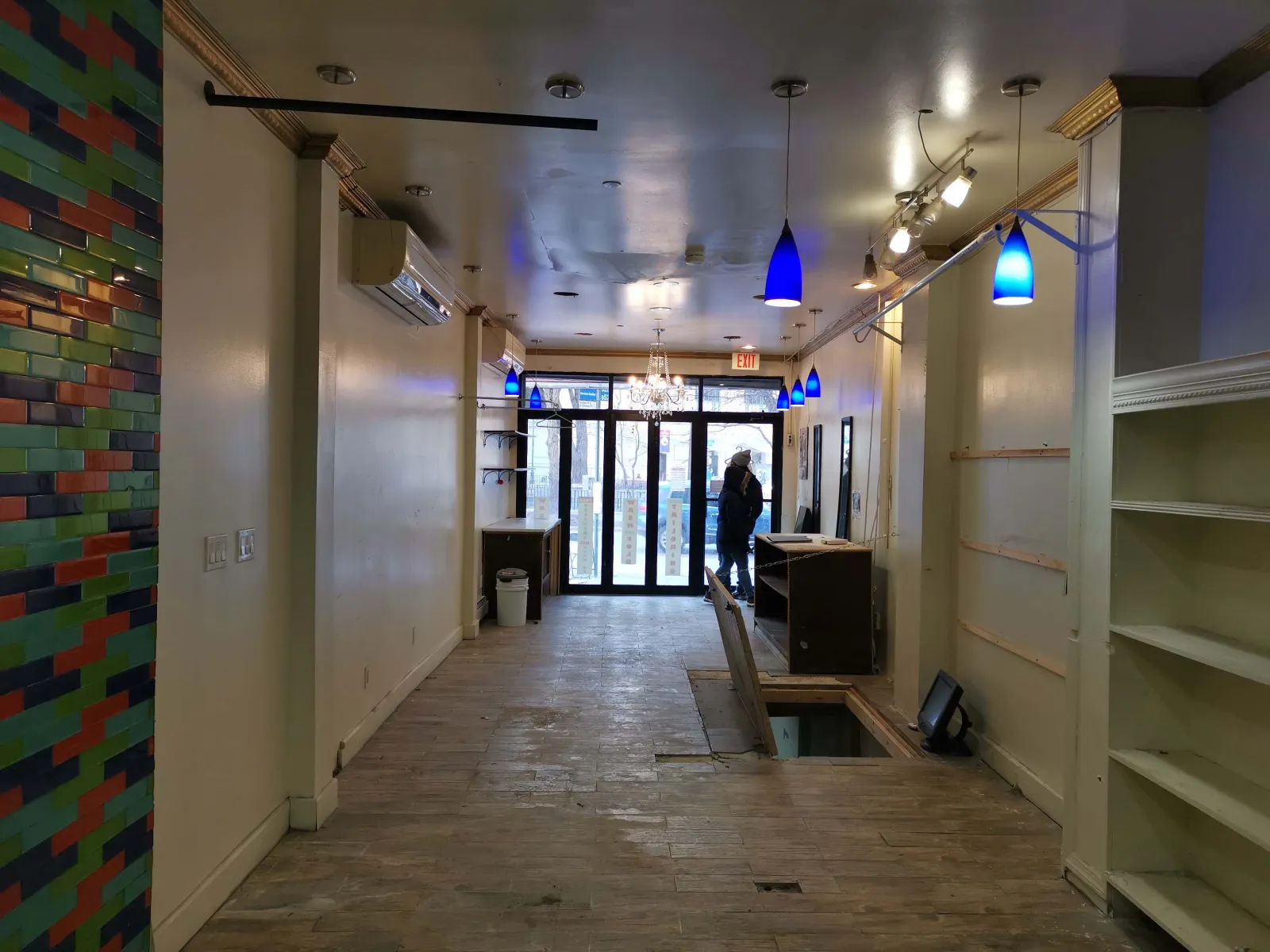 711 Fulton Street — Main floor looking toward the Fulton Street storefront — gutted shell to finished café with coffee bar and bright service counter. — before