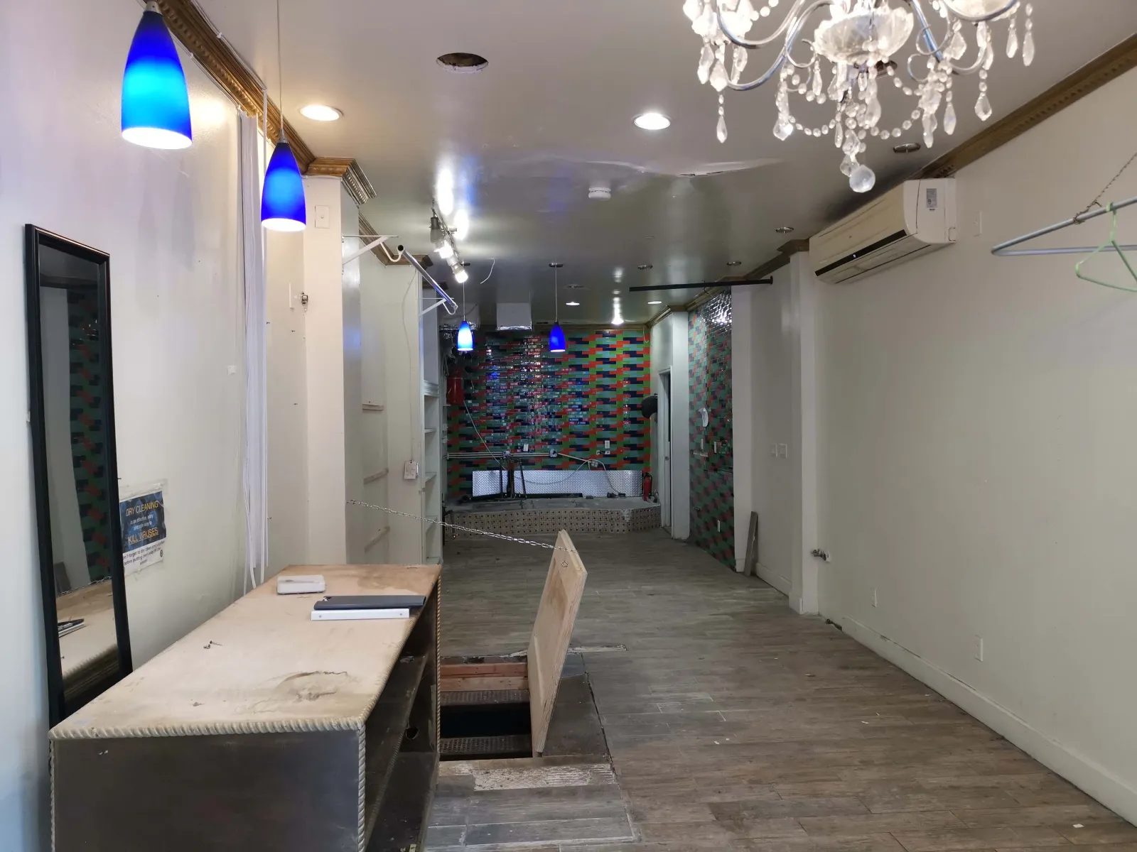 711 Fulton Street — Full-length dining room — stripped interior transformed into the finished seating area with the custom graffiti feature wall. — before