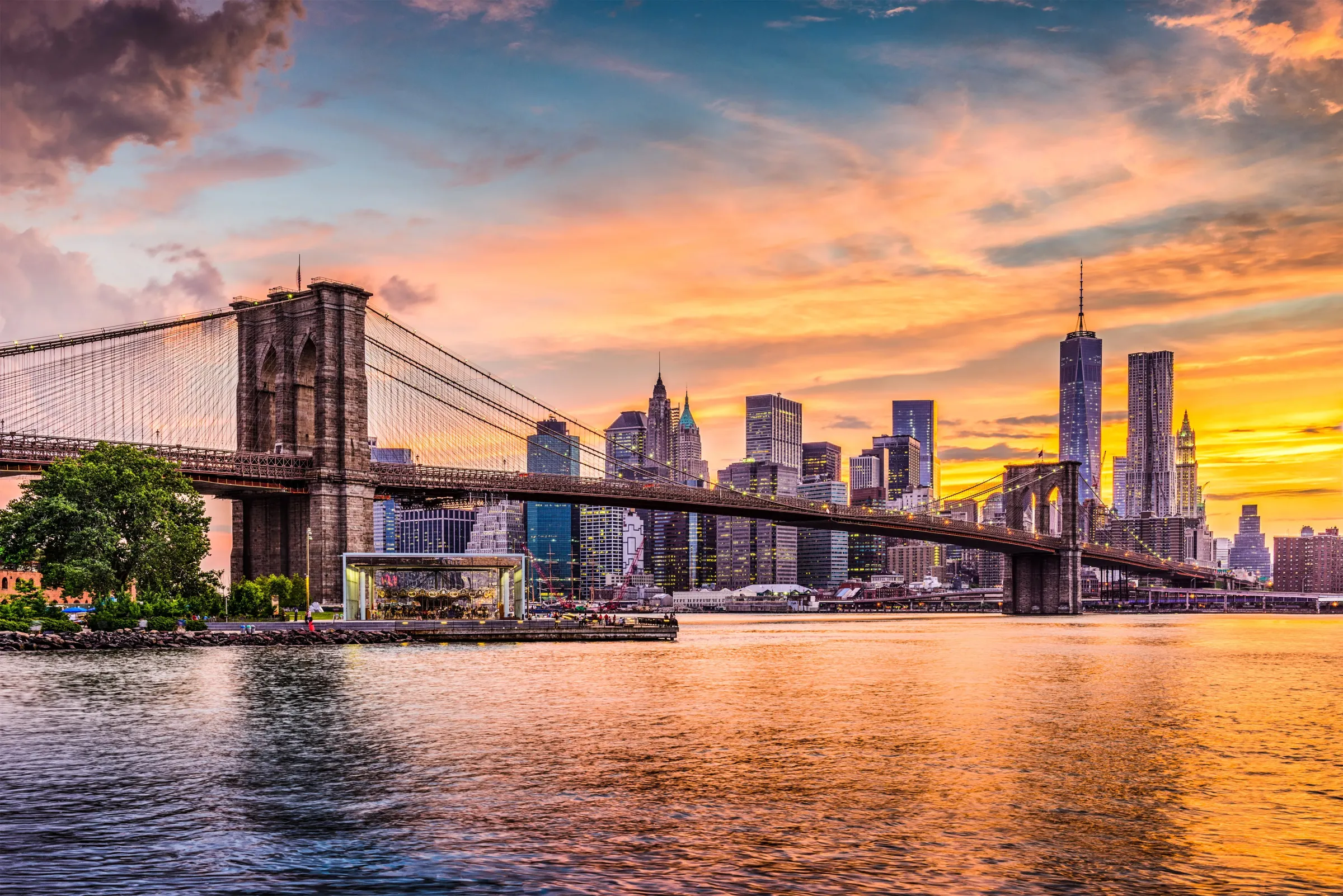 Brooklyn Bridge and the Lower Manhattan skyline at sunset — Prestige Skyline projects built across New York City